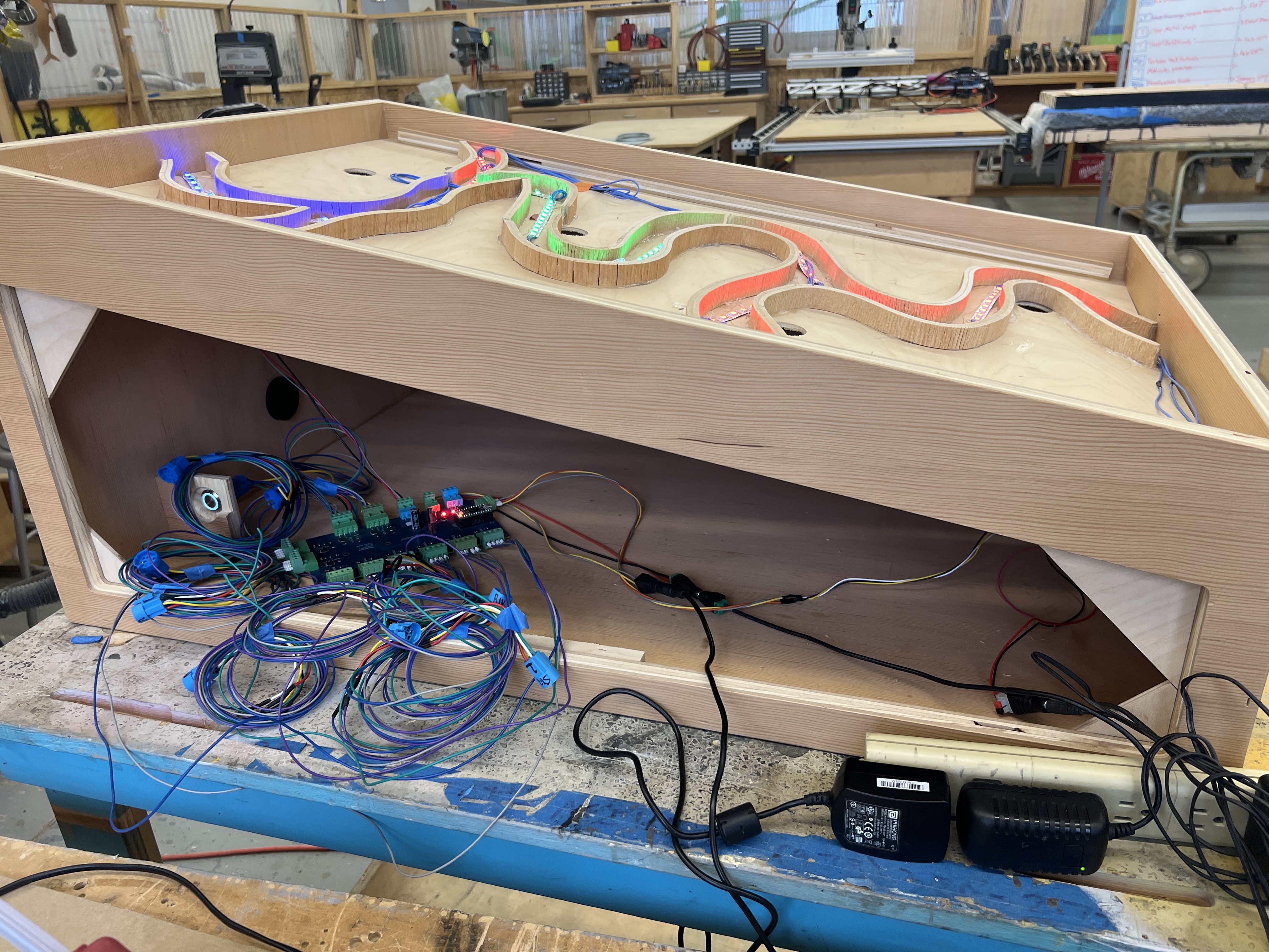 the unfinished project, the box is open to show the wires and circuit board inside of the project, the led strip is shown as the top cover is off.